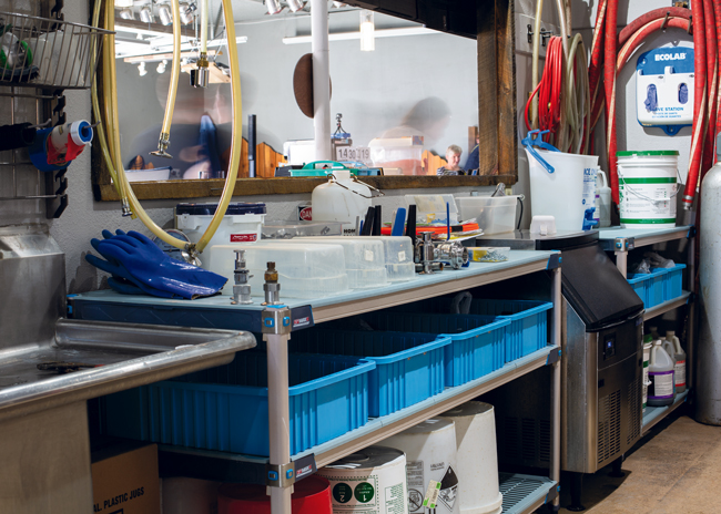 Easily cleanable shelving and trays help bring organization to the brewery room.