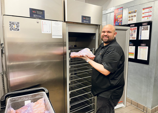 Here, a worker at a fried-chicken concept moves frozen poultry to the cabinet. High-volume, takeout-focused cooking increasingly requires thawing cabinets to bring frozen foods up to temperature safely and reduce cooking times, says Mark Rossi, CEO of Avanti Restaurant Solutions.  Photo by Kayli Green; photo courtesy of Avanti Restaurant Solutions