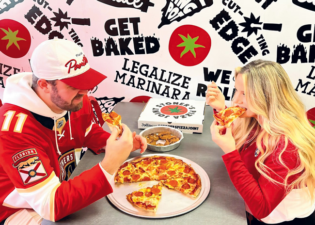 Stoner’s Pizza Joint units, most in second- generation, delivery/takeout-focused locations,  are dressed with wallpaper sporting bold brand colors (red and black) and slogans that give  playful nods to marijuana lingo.  Images courtesy of Stoner’s Pizza Joint