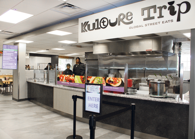 The new  Foodiverse food hall format from Sodexo is designed as a “culture trip,” resembling a European market hall with much of the food prep out front in view of patrons.  Photo courtesy of Sodexo