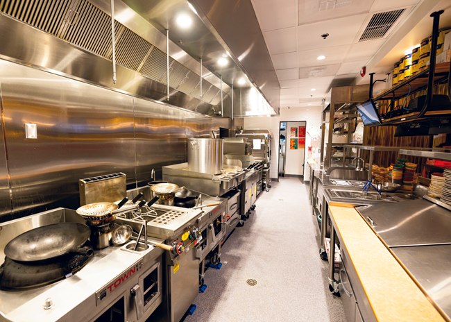 Hawkers’ open kitchen features a hot line along the back wall and a cold line facing the dining area. Cooked items are passed from the cold line to expo for finishing touches.