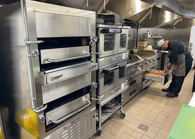 The back of the house contains a deck oven, combi ovens, a range and a griddle.