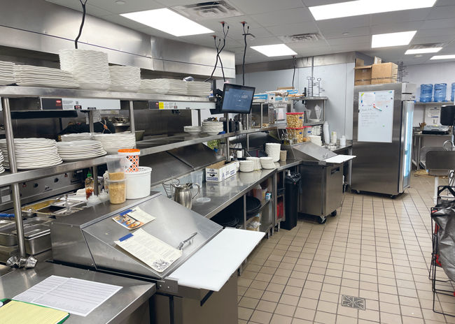 Staff assemble menu items before serving.