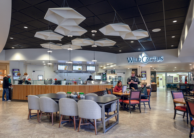 At Royal Oaks Retirement Community in Sun City, Ariz., Scopos Hospitality Group transformed six venues into efficient branded spaces embracing a desert aesthetic: Thrive Coffee Shop, Oasis Market, Wild Cactus Bistro & Grill, Sonrei Expo Restaurant, Willow Reserve Wine Room and 1983 Pub. Features like a robotic busing system, self-checkout market and cooking demonstrations elevate service  and engagement. Photo courtesy of SCOPOS  Hospitality Group; photo by Michael Duerinckx
