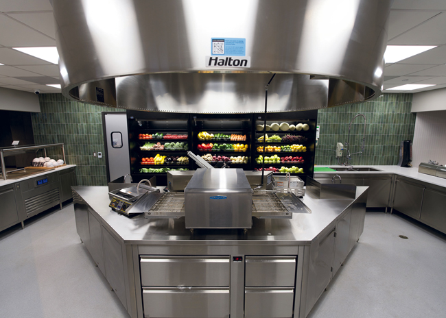 Fresh produce and a conveyor oven are the centerpieces in this servery.  Photo by Kyle Barber