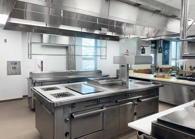 The cooking suite contains two open burners, two induction burners, a French top and a plancha.  Photo by Sharon Ching
