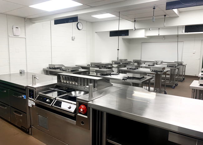 The instructor’s counter features a versatile custom-built ventless induction cooking station with a built-in hand sink and undercounter refrigerated  drawers.  Photos by Sharon Ching 